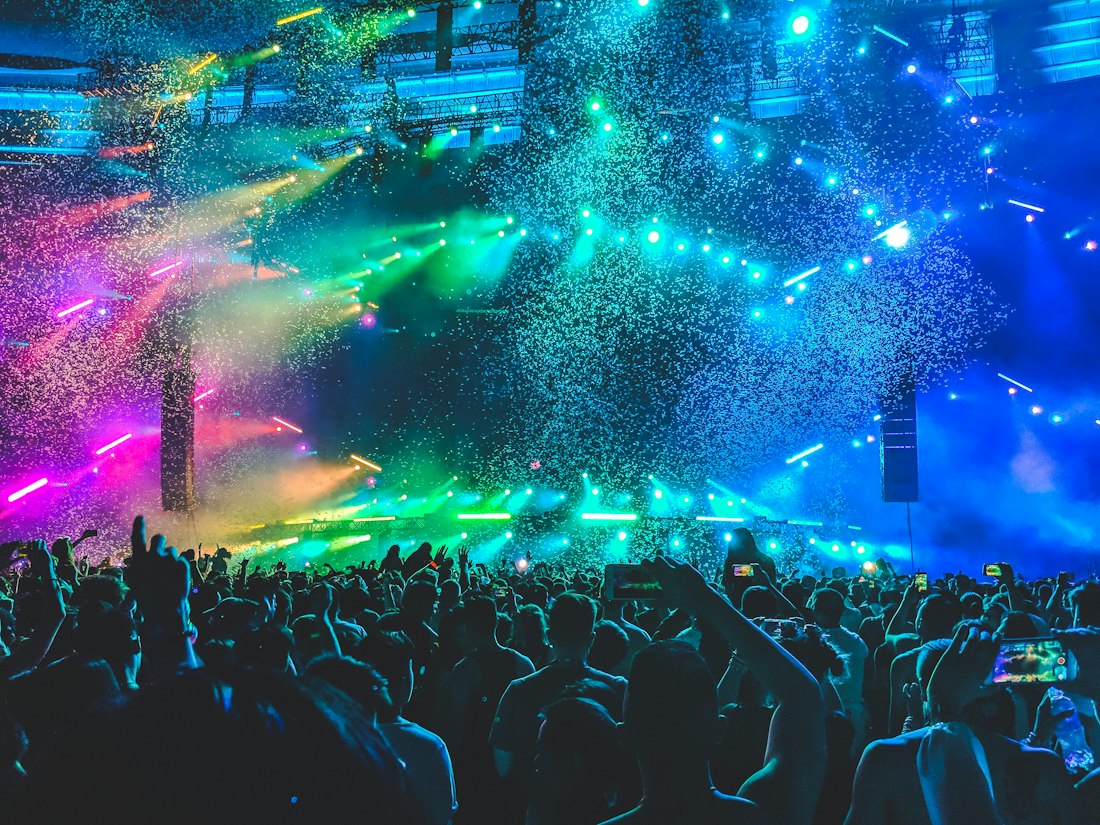 Concert crowd beneath colorful stage lights, placeholder for an event film